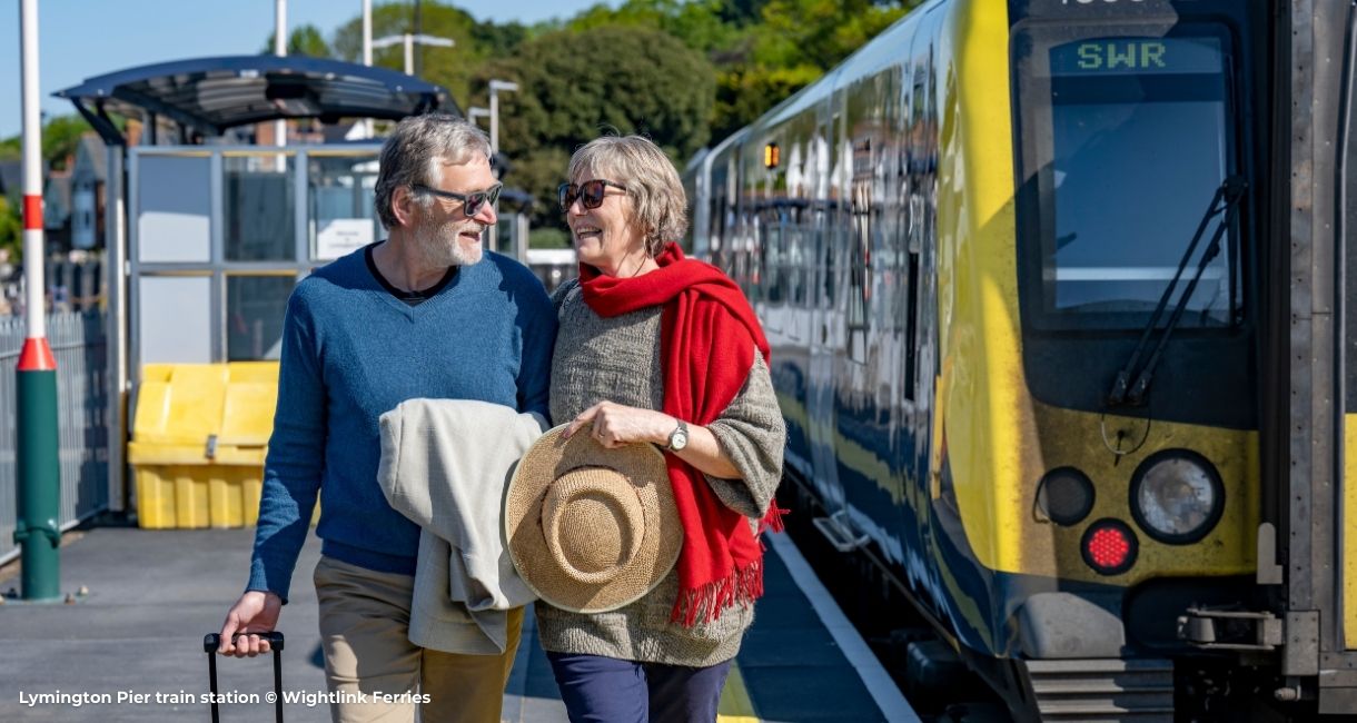 Couple arriving into Lymington Pier train station, ready to board Wightlink ferry